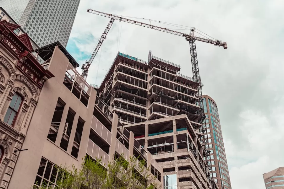 Crane and construction on multi-story buildings in downtown Houston, Texas.
